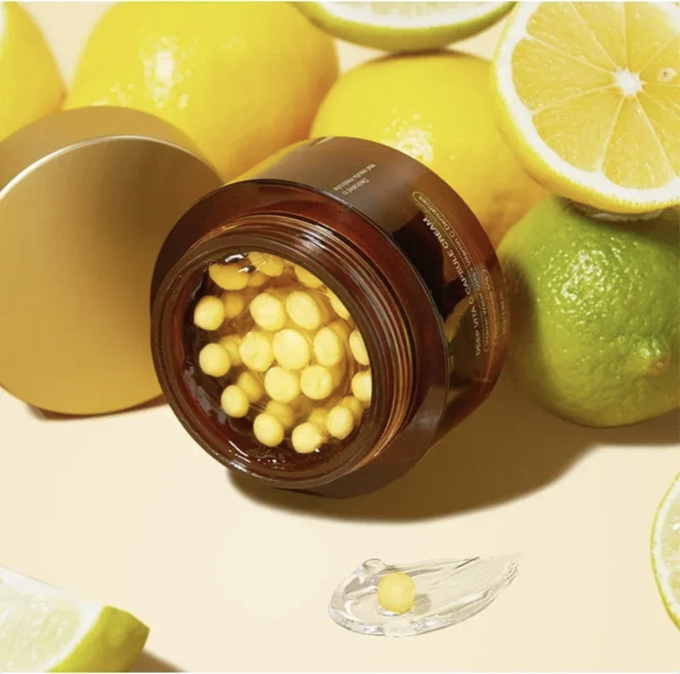 VELERIA Vitamin C Gold Capsule Facial Moisturizer jar opened, showing gold capsules, surrounded by fresh lemons